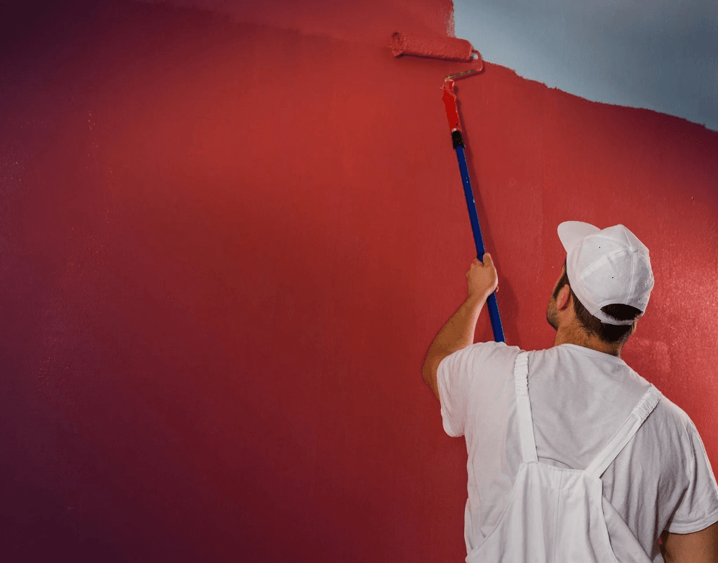 Painter rolling fresh paint onto an interior wall